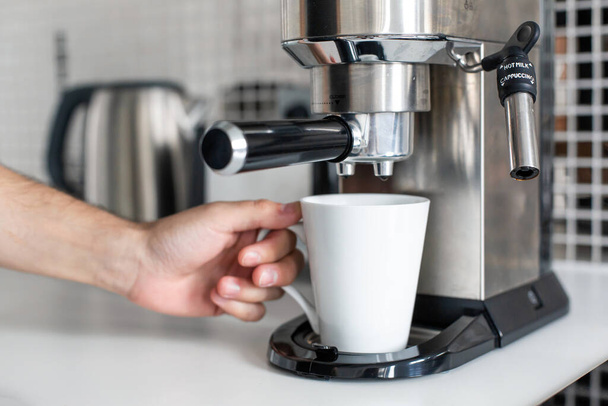 Guy prepare delicious aromatic coffee in a coffee machine. A simple way to make coffee. - Photo, Image