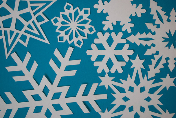 Various paper handmade snowflakes on light blue background - 写真・画像