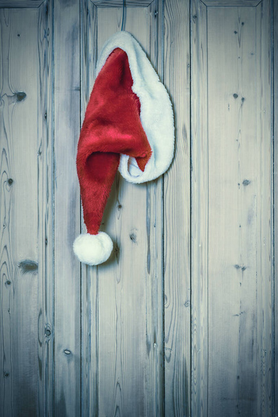 Santa hangs up his hat after delivering presents at Christmas - Фото, изображение