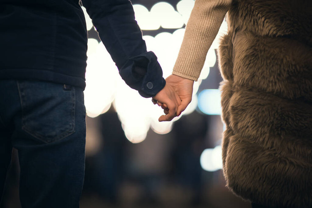 Loving couple holding hands taking a walking - Foto, imagen