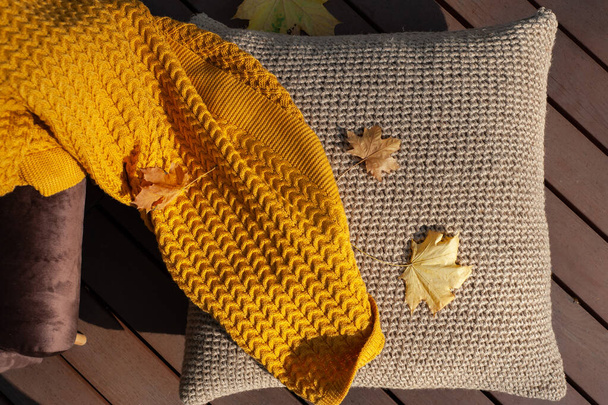 yellow blanket and jute flooring pillow on autumn terrace  - Photo, Image