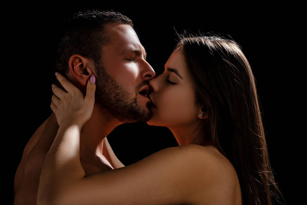 Kissing couple in love. Intimate foreplay of attractive lovers. - Fotó, kép