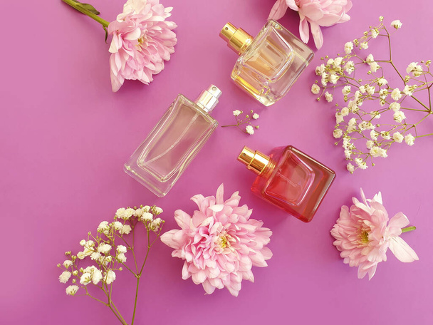 bottle perfume flower on a colored background - Photo, Image