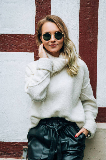 Portrait of pretty stylish blonde girl with sunglasses outdoors - Фото, изображение