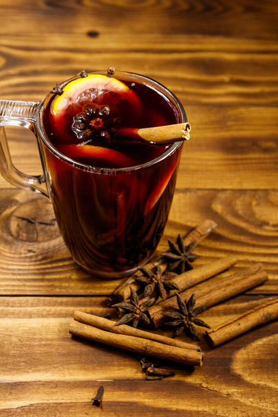Mulled wine and spices on wooden table - Photo, Image