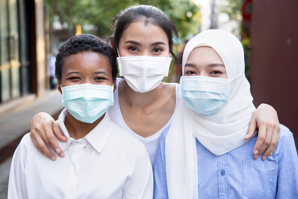 Friend group of diverse people Asian, black African, Muslim people all wearing face mask for new normal lifestyle and social distancing - Photo, Image