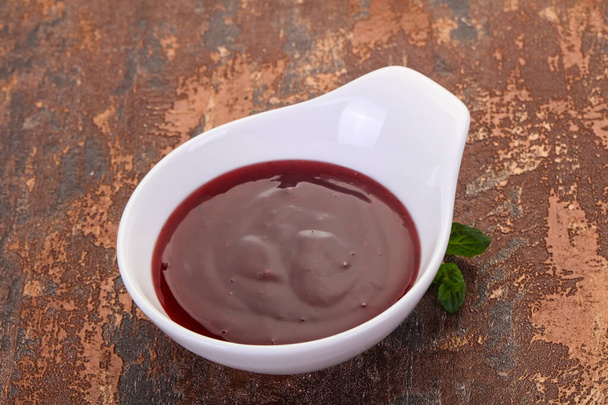 Delicous cowberry sauce with mint leaves - Photo, Image