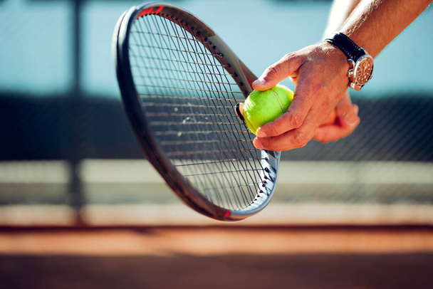 Tennis players hand preparing to take a serve - Foto, Imagem
