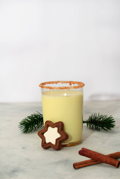 Classic winter Christmas drink egnog in glass with chocolate chip cookies and decor on a concrete background. Copy space. - Fotoğraf, Görsel