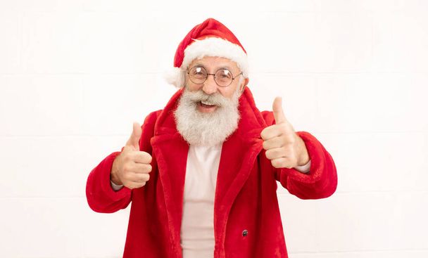 Santa Claus showing thumbs up posing isolated on white background - Valokuva, kuva