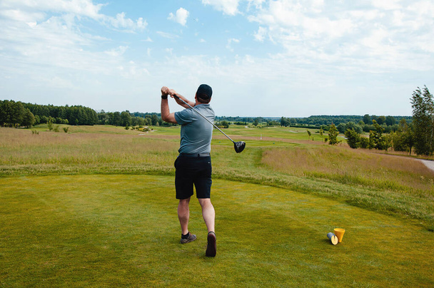 Joueur de golf masculin sur un terrain de golf professionnel. Golfeur avec club de golf prenant un tir - Photo, image