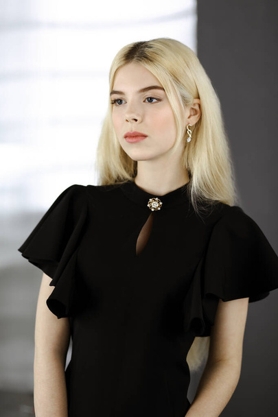 Young blonde business woman or female student in black is standing straight and posing at camera. Lifestyle and diverse people concept - Fotoğraf, Görsel