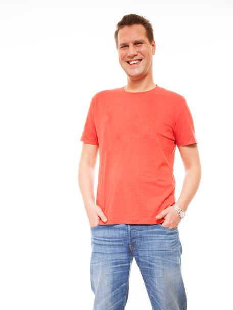 Young man guy red t-shirt jaens with hands in pockets isolated - Foto, Bild