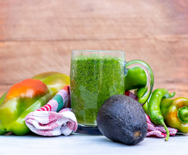 Healthy smoothie wraped with towel and green vegetables - Photo, Image