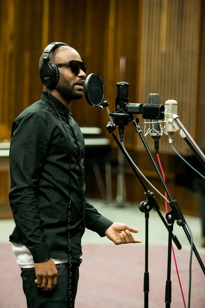 Johannesburg, South Africa - February 17, 2014: African Artist Fally Ipupa, DRC singing in a SABC recording studio - 写真・画像