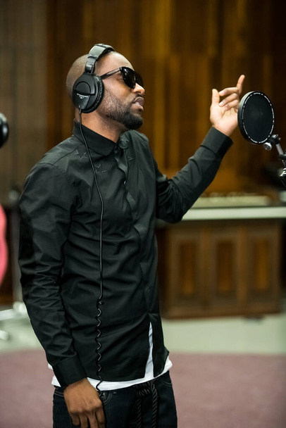 Johannesburg, South Africa - February 17, 2014: African Artist Fally Ipupa, DRC singing in a SABC recording studio - Foto, afbeelding