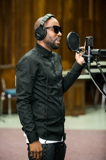 Johannesburg, South Africa - February 17, 2014: African Artist Fally Ipupa, DRC singing in a SABC recording studio - Zdjęcie, obraz