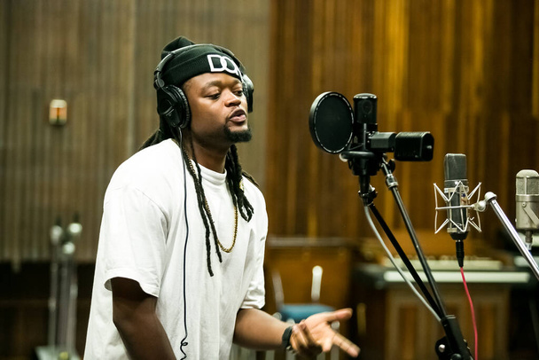 Johannesburg, South Africa - February 17, 2014: African Artist Buffalo Souljah, Zimbabwe singing in a SABC recording studio - Foto, immagini