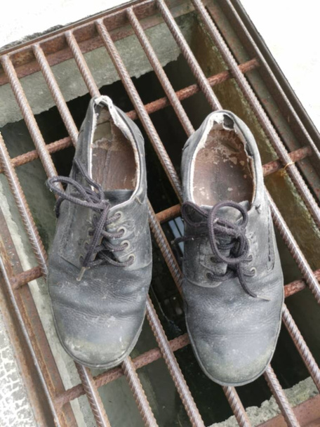 worn out man 's black leather shoe. - Фото, изображение