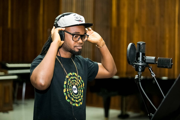 Johannesburg, South Africa - February 17, 2014: African Artist Dontom, Nigeria singing in a SABC recording studio - Zdjęcie, obraz