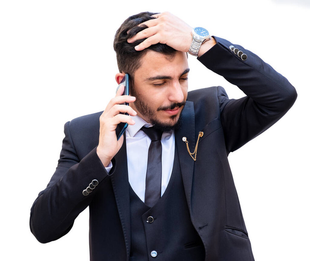 Business man arguing and discussing the work using mobile phone in a call or video call to maintain business follow and stay followed up with the work updates with respect to time - Foto, imagen