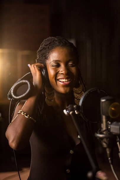 Johannesburg, South Africa - February 18, 2014: African Artist Nancy G, Swaziland singing in a SABC recording studio - 写真・画像