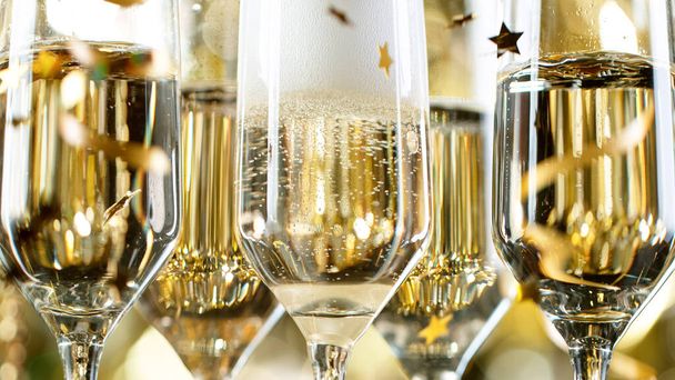 Champagne Flutes with Bubbles on Golden Light Background - Fotó, kép