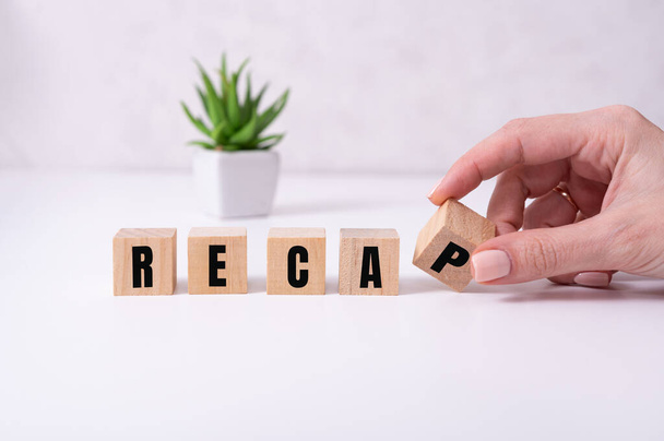 concept word RECAP on wooden cubes on a white background - Фото, изображение