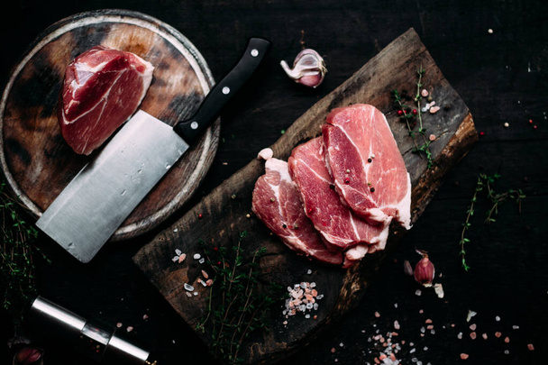 Raw pork steak on a wooden table - Fotó, kép