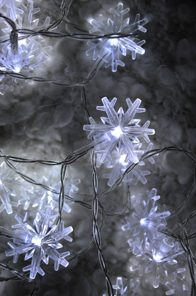 garland for the holiday. decor for a Merry Christmas and Happy New year. bright glowing light bulbs. - 写真・画像