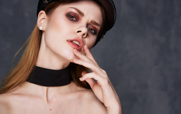 Pretty woman black hat decoration cosmetics dark background - Fotografie, Obrázek