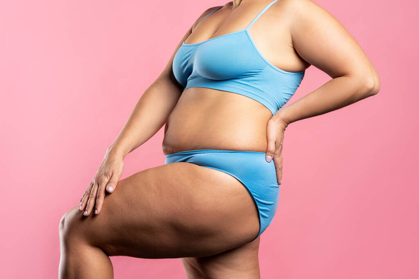 Fat woman in blue underwear on pink background, overweight female body, studio shot with copy space - Fotografie, Obrázek