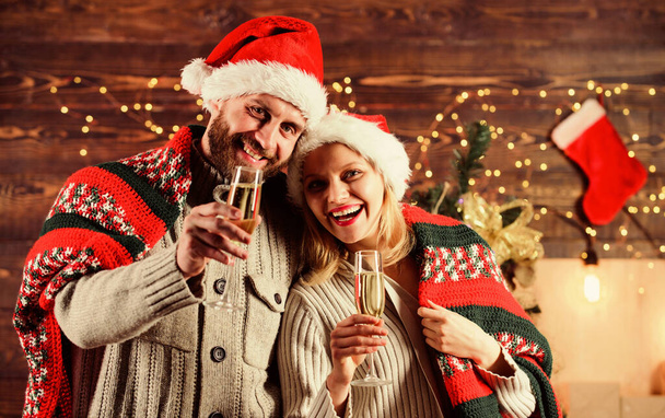 Home party. Festive atmosphere. Make christmas wish. Couple in love cuddling enjoy christmas holiday celebration. Drinks for adults. Happy new year. Merry christmas. Celebrating christmas together - Photo, image