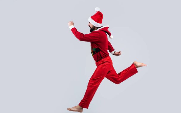 happy bearded guy in red santa claus costume running feel happiness about christmas shopping sales, xmas - Photo, image