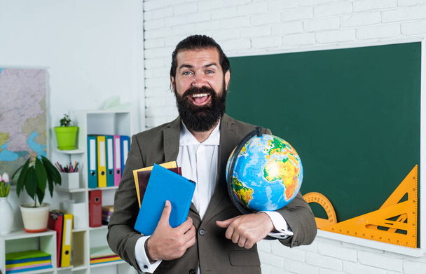 mature bearded geographer with beard and moustache wear suit in school classroom, education - Foto, Imagem