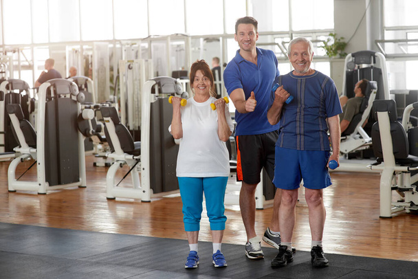 Senior people with trainer at fitness club. - Zdjęcie, obraz