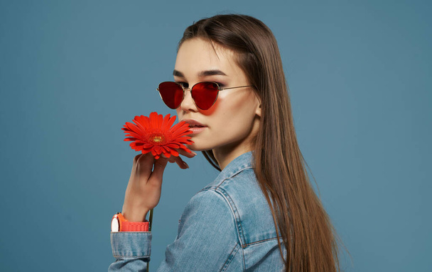 ελκυστική γυναίκα κόκκινο λουλούδι που κατέχουν γυαλιά μόδας καλλυντικά πολυτελείας στούντιο - Φωτογραφία, εικόνα