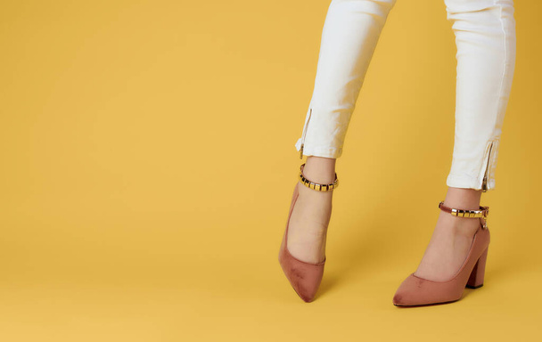 Weibliche Füße weiße Turnschuhe Schuhe Mode gelb Hintergrund - Foto, Bild