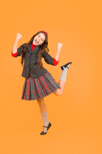 Happy little girl child in school uniform with winning gestures enjoy celebration, scholarship - Foto, Imagem