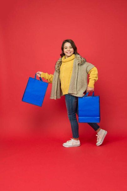 From purchase to delivery. Energetic kid carry shopping bags. Paper carrier bags and packs. Season sale. Discount galore for thing you adore - Photo, image