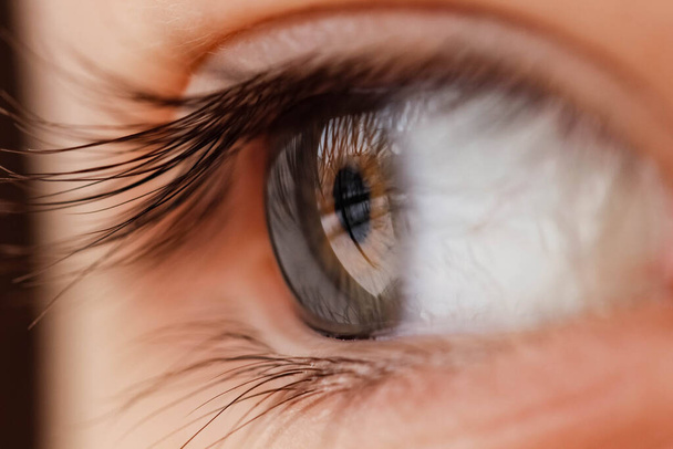 Macro photography of a girl's eye that looks away. Blurred edges. Macro, selective shot. - Фото, изображение