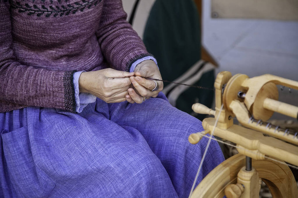 Spinner working in sewing with wool, artisan production, industry - Φωτογραφία, εικόνα