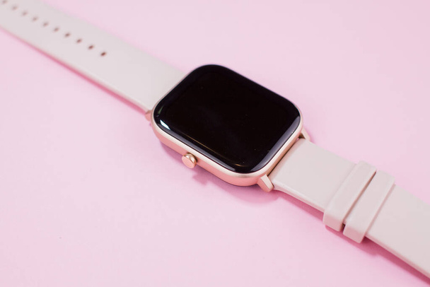 women smart watch on a pink background - Foto, Imagen
