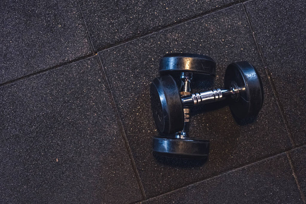 two iron dumbbells in gym gary background workout - Photo, image