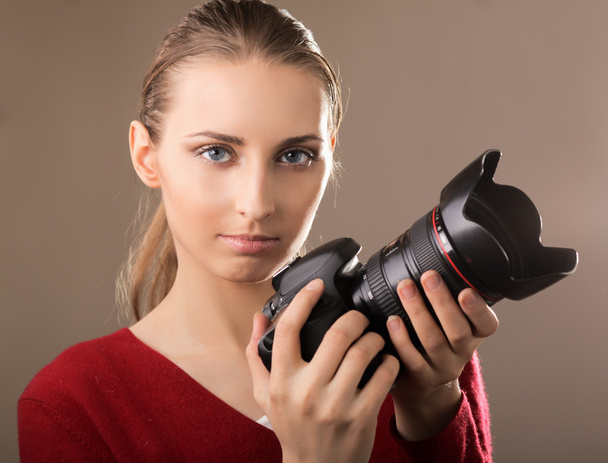 Beautiful young woman with camera - Photo, image