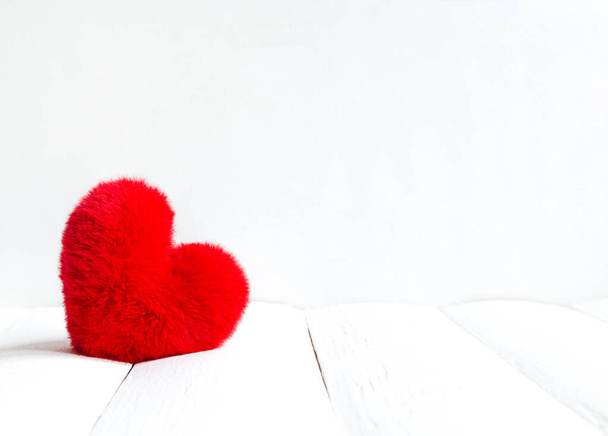 Red soft heart on a white wooden background for valentine day with copy space - Foto, Imagen
