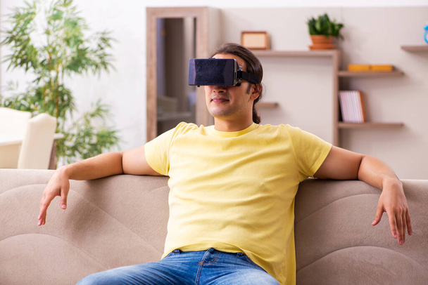 Young man student with virtual glasses at home - Valokuva, kuva