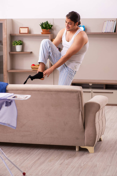 Joven empleado masculino levantándose tarde en casa - Foto, Imagen
