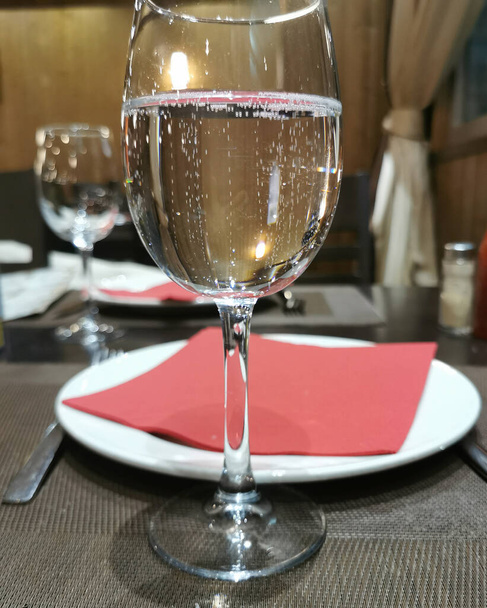glass on the background of the served restaurant table - Photo, Image