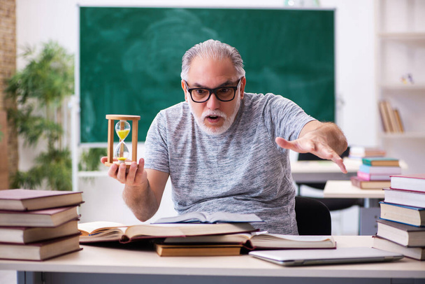 Old male student in time management concept - Photo, Image